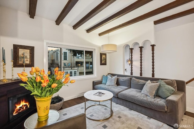 50 Perine Pl, San Francisco, CA 94115 - living area featuring beamed ceiling, wood finished floors, a lit fireplace, and baseboards
