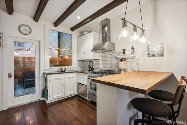 50 Perine Pl, San Francisco, CA 94115 - kitchen featuring wall chimney exhaust hood, high end range, butcher block countertops, decorative backsplash, and a kitchen breakfast bar