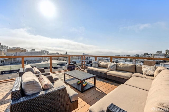 deck with an outdoor living space and a city view