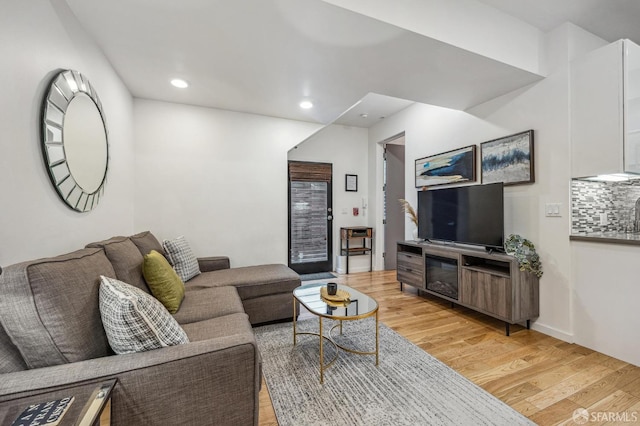 living area featuring light wood-style floors and recessed lighting