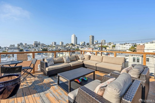 wooden terrace with a view of city and outdoor lounge area