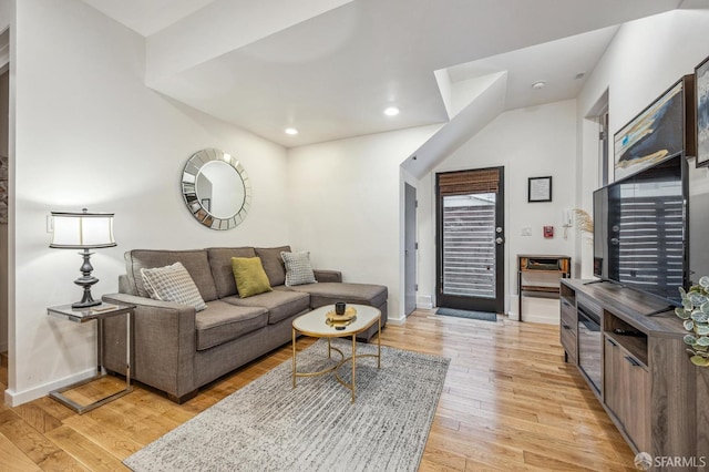 living room with light wood-style flooring, baseboards, and recessed lighting