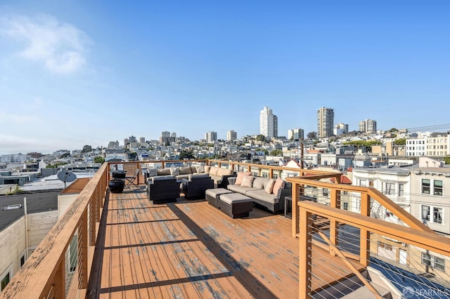 wooden deck with an outdoor hangout area and a city view