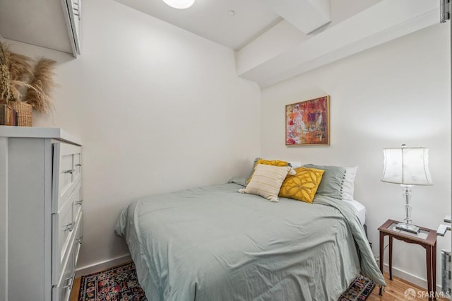 bedroom featuring baseboards and wood finished floors