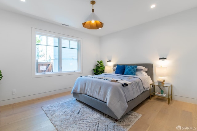 bedroom featuring recessed lighting, visible vents, light wood finished floors, and baseboards