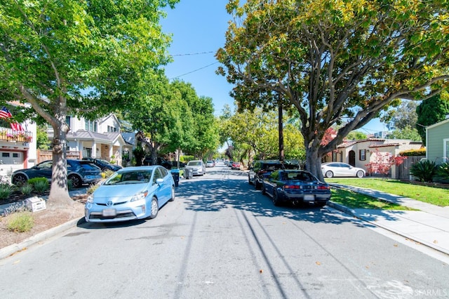 view of road featuring curbs, a residential view, and sidewalks