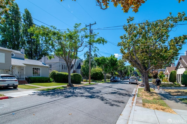 view of street with curbs, sidewalks, and a residential view