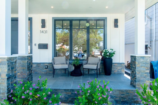 view of exterior entry featuring covered porch