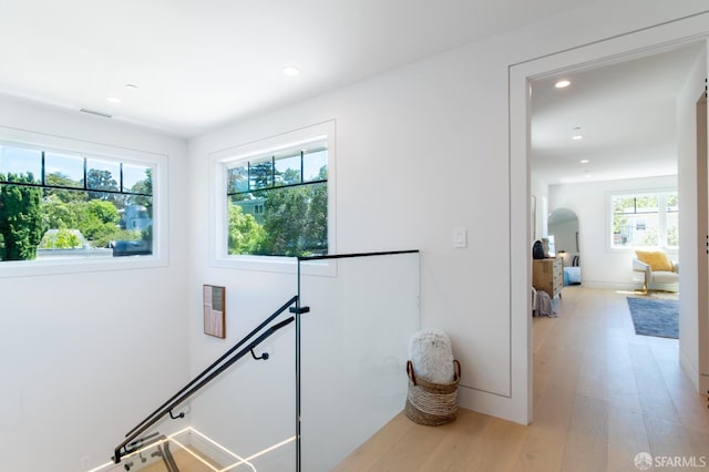 hallway featuring an upstairs landing, recessed lighting, and light wood-style floors