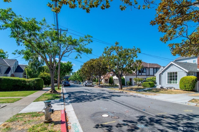 view of road with curbs, sidewalks, and a residential view