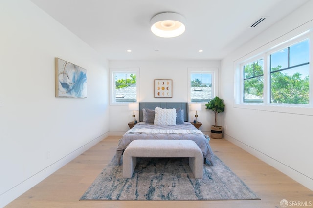 bedroom featuring recessed lighting, visible vents, baseboards, and light wood finished floors