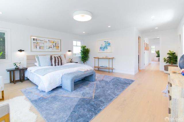 bedroom with recessed lighting, baseboards, and light wood-style floors