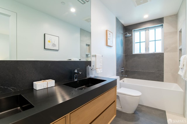 full bathroom featuring visible vents, toilet, shower / bathtub combination, backsplash, and vanity