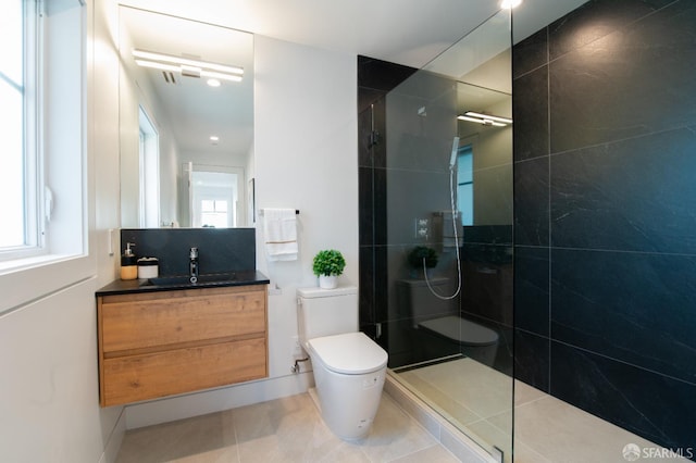 full bathroom with tile patterned floors, toilet, vanity, and walk in shower