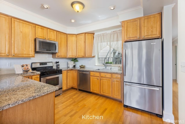 4471 Mission St Unit 2, San Francisco, CA 94112 - kitchen with stainless steel appliances, a sink, light wood finished floors, light stone counters, and ornamental molding