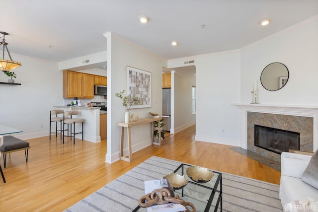 4471 Mission St Unit 2, San Francisco, CA 94112 - living room with light wood-style flooring, crown molding, baseboards, a fireplace, and recessed lighting