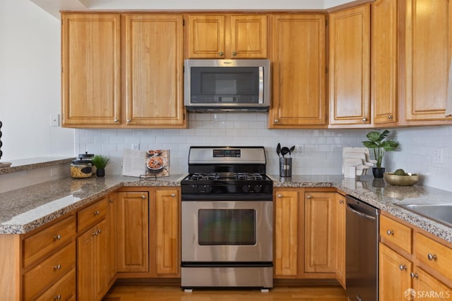4471 Mission St Unit 2, San Francisco, CA 94112 - kitchen with stainless steel appliances, backsplash, light stone countertops, and light wood-type flooring