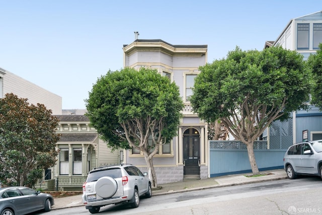 view of front of home featuring fence