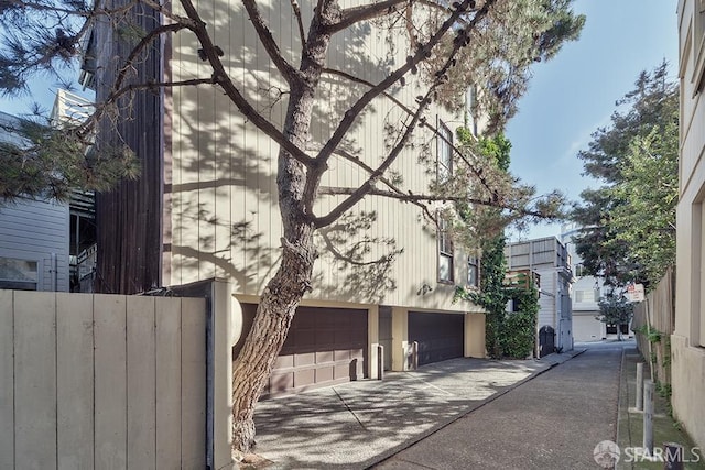 view of home's exterior with a garage and driveway