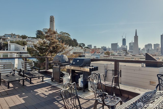 view of patio / terrace featuring a skyline view, a balcony, and a grill