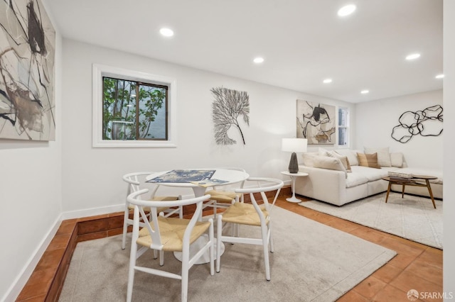 dining room with tile patterned floors and a wealth of natural light