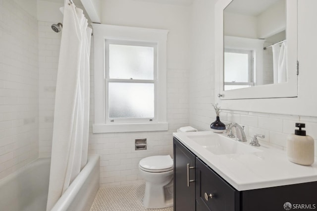 full bathroom with vanity, tile walls, shower / tub combo, and toilet