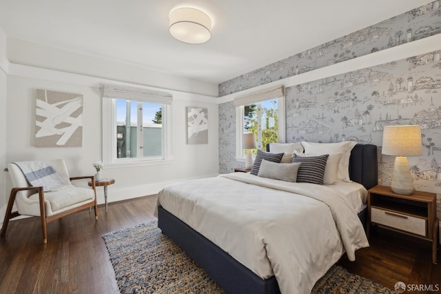 bedroom with multiple windows and dark wood-type flooring