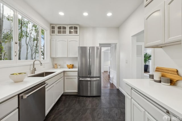 kitchen with sink, white cabinets, and appliances with stainless steel finishes