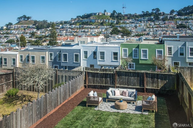 exterior space featuring outdoor lounge area and a fenced backyard