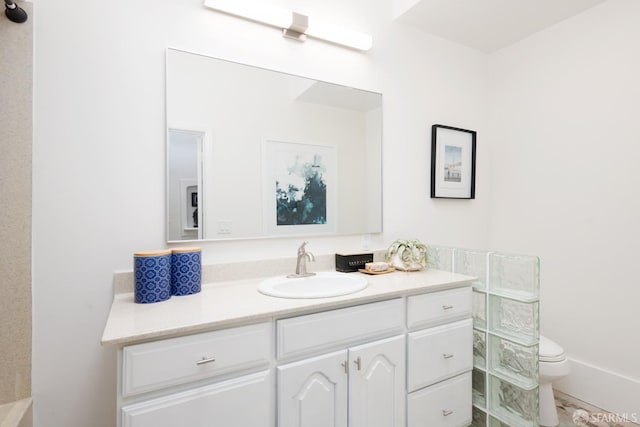 bathroom featuring vanity and toilet