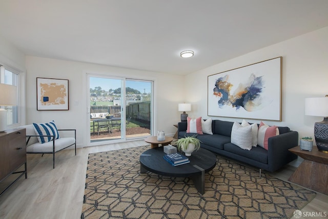 living room featuring light wood-type flooring and a wealth of natural light