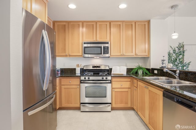 1488 El Camino Real Unit 212, South San Francisco, CA 94080 - kitchen with stainless steel appliances, light brown cabinets, dark stone countertops, hanging light fixtures, and recessed lighting