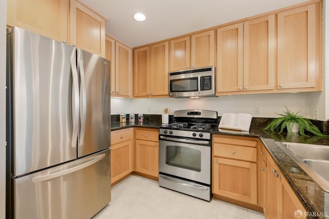 1488 El Camino Real Unit 212, South San Francisco, CA 94080 - kitchen with appliances with stainless steel finishes, light brown cabinetry, dark stone counters, and recessed lighting