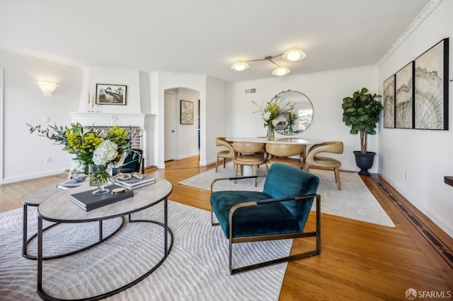 living room featuring hardwood / wood-style flooring and crown molding