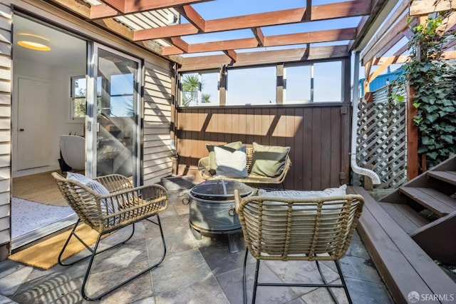 view of patio / terrace featuring a pergola and a fire pit