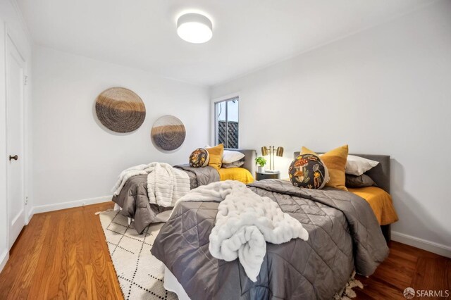 bedroom with hardwood / wood-style floors