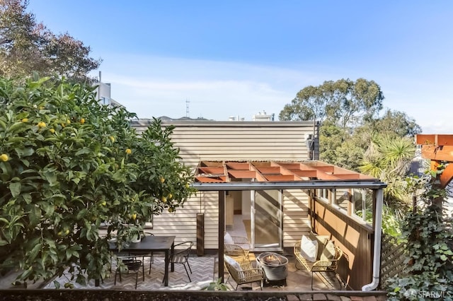 rear view of house featuring a pergola and a patio