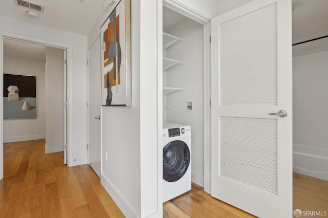 566 S Van Ness Ave Unit 31, San Francisco, CA 94110 - washroom with washer / clothes dryer and light wood-type flooring