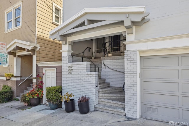 207 Eureka St, San Francisco, CA 94114 - view of exterior entry featuring covered porch, a garage, and brick siding