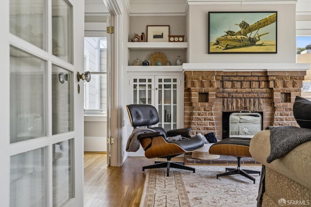 207 Eureka St, San Francisco, CA 94114 - living area featuring a fireplace, wood finished floors, and crown molding
