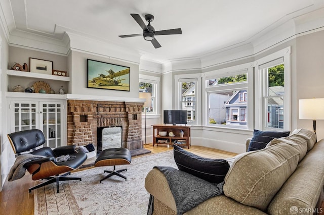 207 Eureka St, San Francisco, CA 94114 - living room featuring ornamental molding, wood finished floors, a brick fireplace, and plenty of natural light