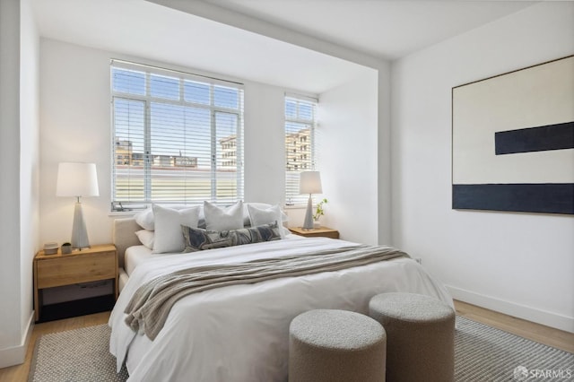 bedroom featuring wood finished floors and baseboards