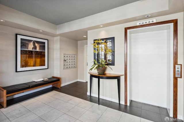 tiled foyer featuring baseboards and recessed lighting