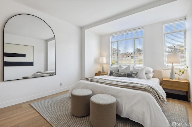 bedroom featuring baseboards and wood finished floors