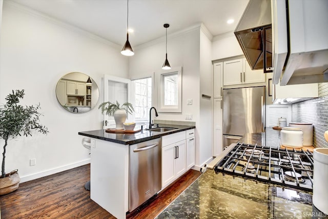 27 Hartford St, San Francisco, CA 94114 - kitchen featuring appliances with stainless steel finishes, a peninsula, crown molding, tasteful backsplash, and dark wood finished floors