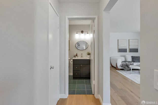 1734 Bay St Unit 103, San Francisco, CA 94123 - corridor with light wood-style floors and a sink