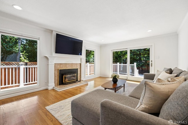 744 Crompton Rd, Redwood City, CA 94061 - living area featuring crown molding, wood finished floors, a tile fireplace, and recessed lighting