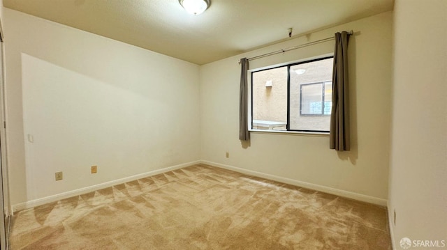 unfurnished room with light colored carpet