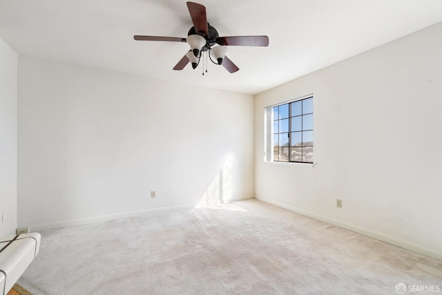 unfurnished room with ceiling fan and light colored carpet