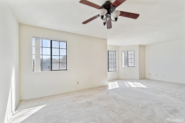 carpeted spare room with ceiling fan